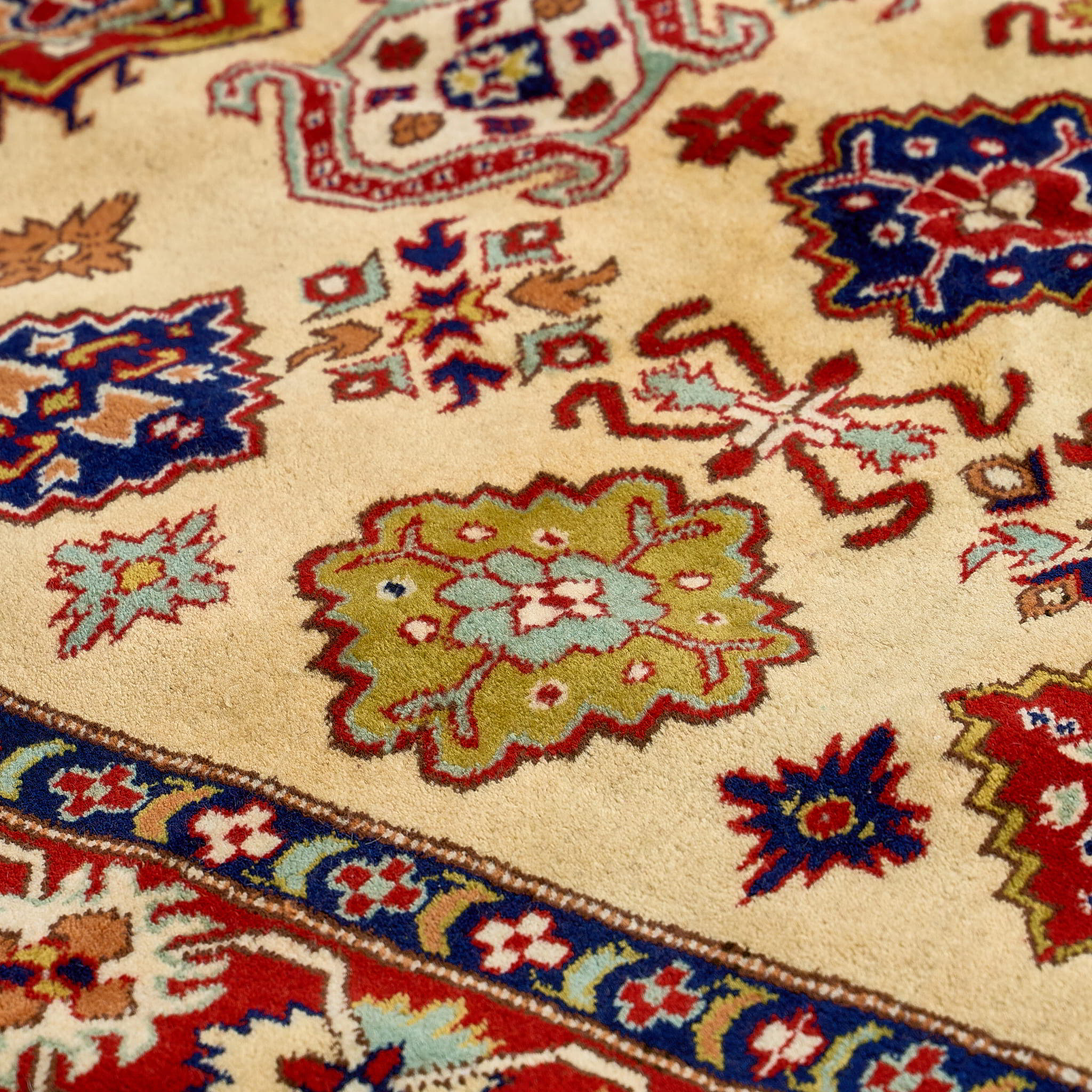 rug in red wool with star-based geometric motif, demonstrating handwoven rug craftsmanship.