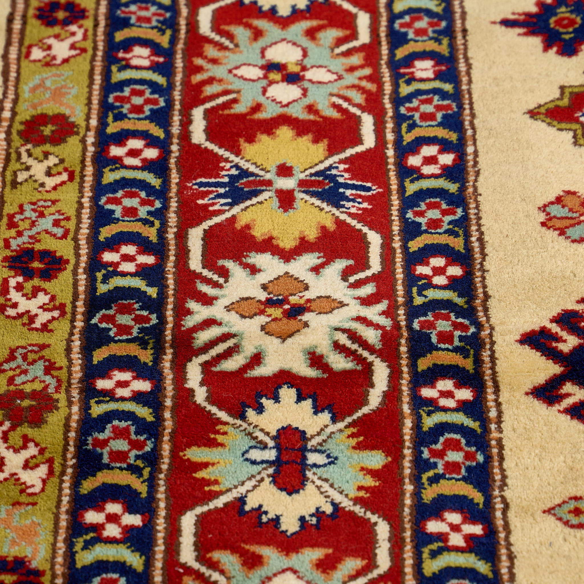 rug in red wool with star-based geometric motif, demonstrating handwoven rug craftsmanship.