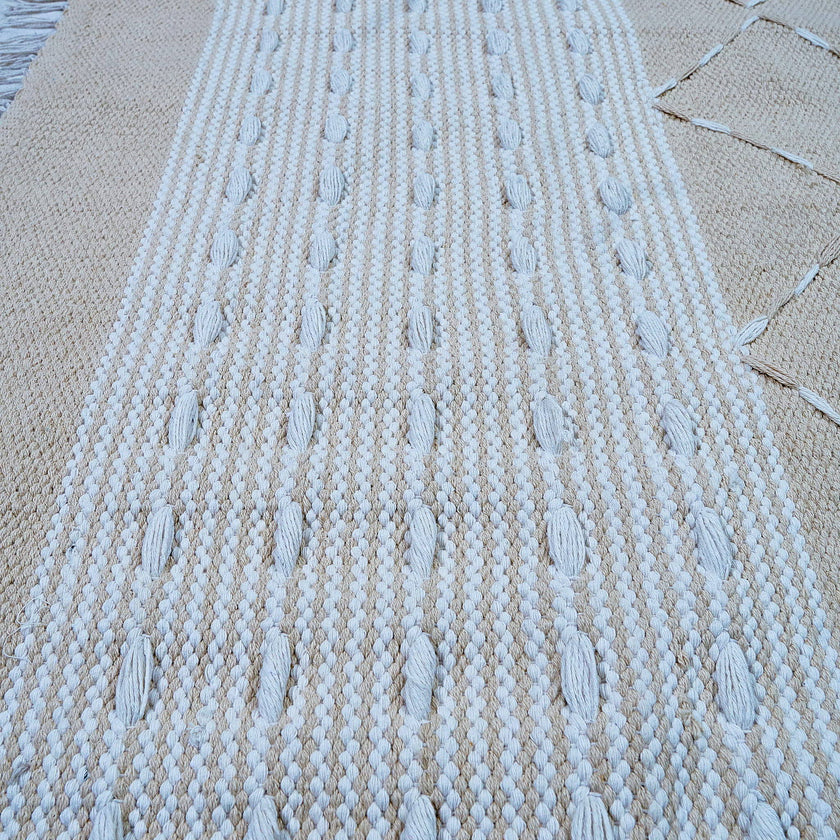 kilim in beige cotton with minimalist stripe/diamond motif, demonstrating kilim craftsmanship.