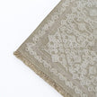rug in beige cotton-silk blend with quiet floral field motif, demonstrating handwoven rug craftsmanship.
