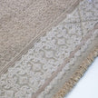 rug in beige cotton-silk blend with quiet floral field motif, demonstrating handwoven rug craftsmanship.