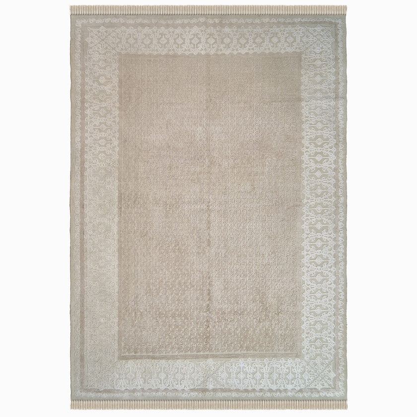 rug in beige cotton-silk blend with quiet floral field motif, demonstrating handwoven rug craftsmanship.
