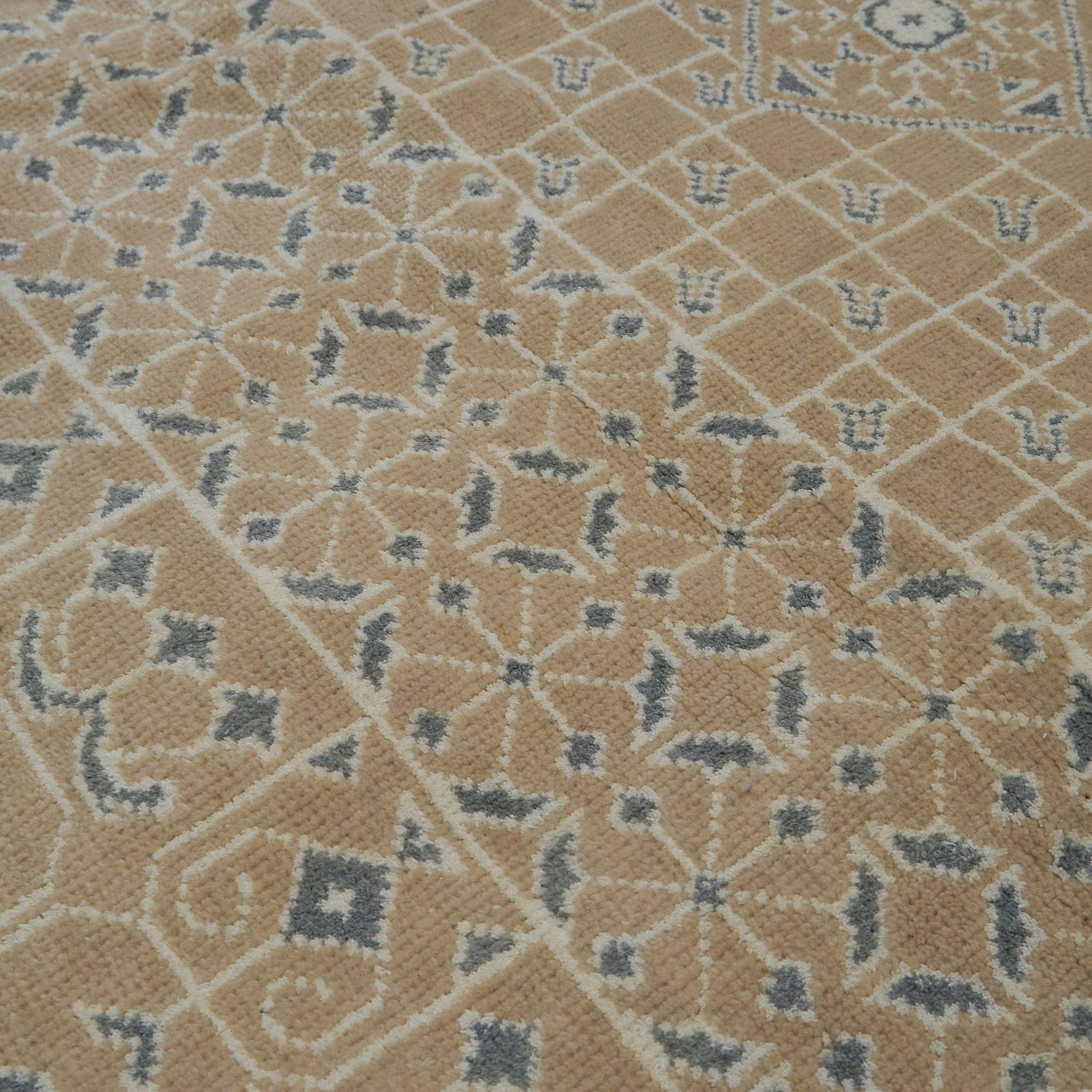 rug in taupe wool–cotton blend with mandala geometric motif, demonstrating handwoven rug craftsmanship.