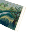 wall art in teal/green wool with nature landscape motif, demonstrating handwoven rug craftsmanship.