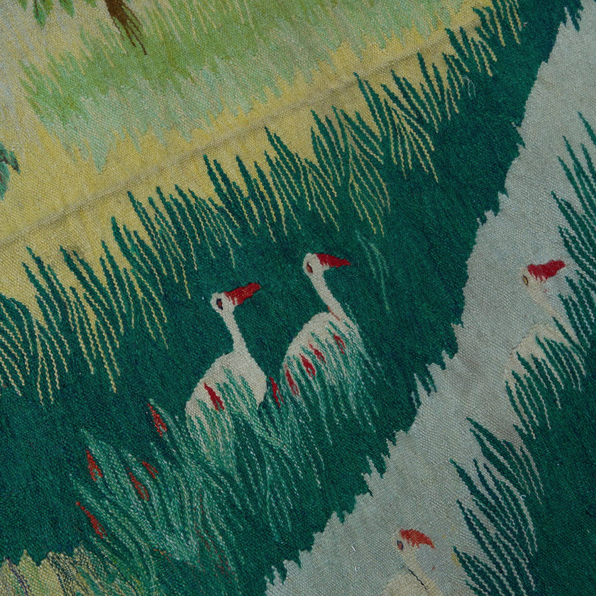 wall art in teal/green wool with nature landscape motif, demonstrating handwoven rug craftsmanship.