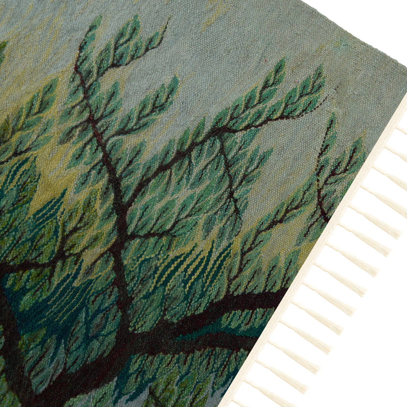 wall art in teal/green wool with nature landscape motif, demonstrating handwoven rug craftsmanship.