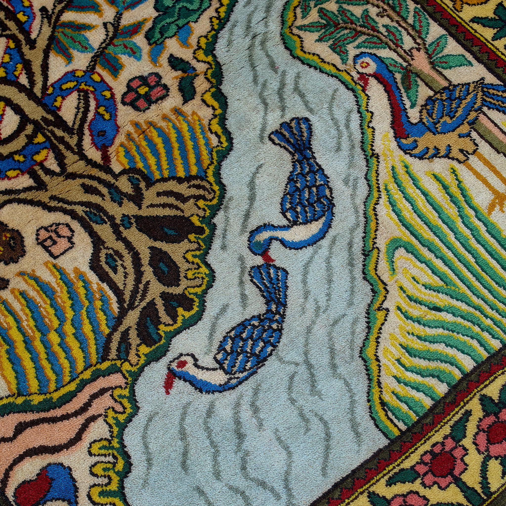 wall art in green wool with figurative village textile motif, demonstrating handwoven rug craftsmanship.