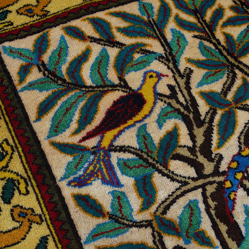 wall art in green wool with figurative village textile motif, demonstrating handwoven rug craftsmanship.