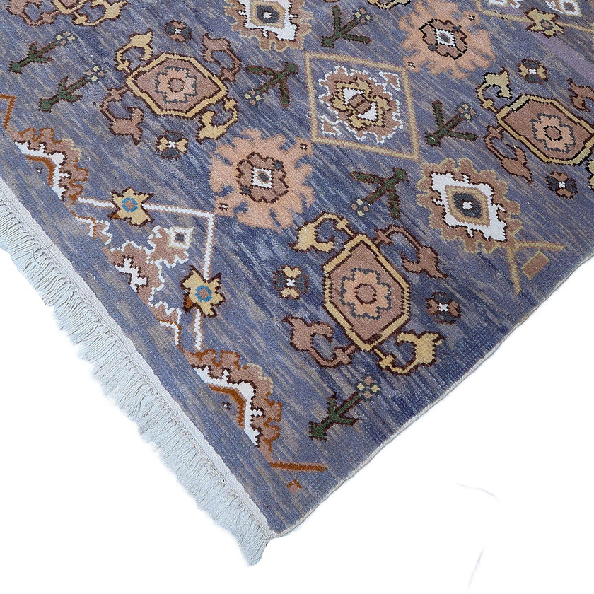 rug in slate grey wool with repeating diamond motif, demonstrating handwoven rug craftsmanship.