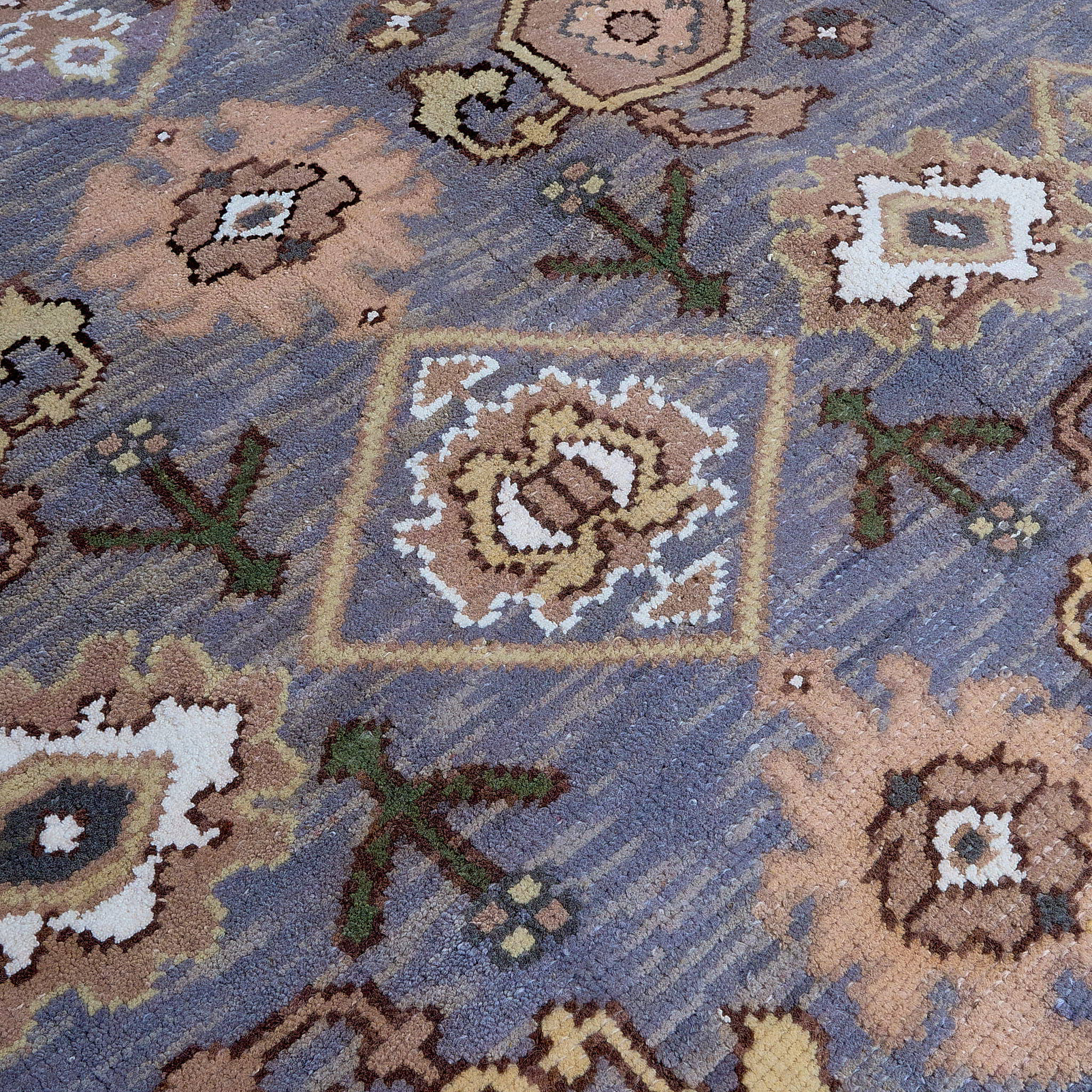 rug in slate grey wool with repeating diamond motif, demonstrating handwoven rug craftsmanship.