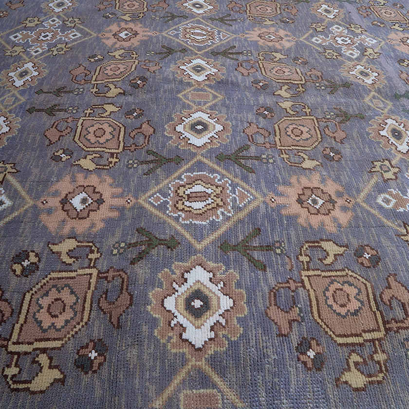 rug in slate grey wool with repeating diamond motif, demonstrating handwoven rug craftsmanship.