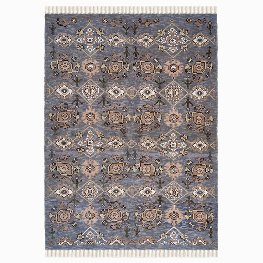 rug in slate grey wool with repeating diamond motif, demonstrating handwoven rug craftsmanship.