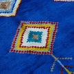 rug in vivid blue wool with tribal diamond motif, demonstrating handwoven rug craftsmanship.