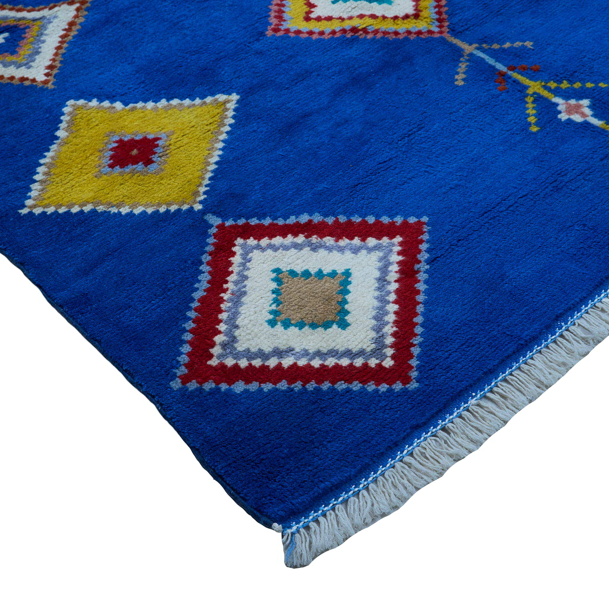 rug in vivid blue wool with tribal diamond motif, demonstrating handwoven rug craftsmanship.