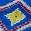 rug in vivid blue wool with tribal diamond motif, demonstrating handwoven rug craftsmanship.
