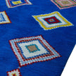 rug in vivid blue wool with tribal diamond motif, demonstrating handwoven rug craftsmanship.