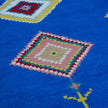 rug in vivid blue wool with tribal diamond motif, demonstrating handwoven rug craftsmanship.